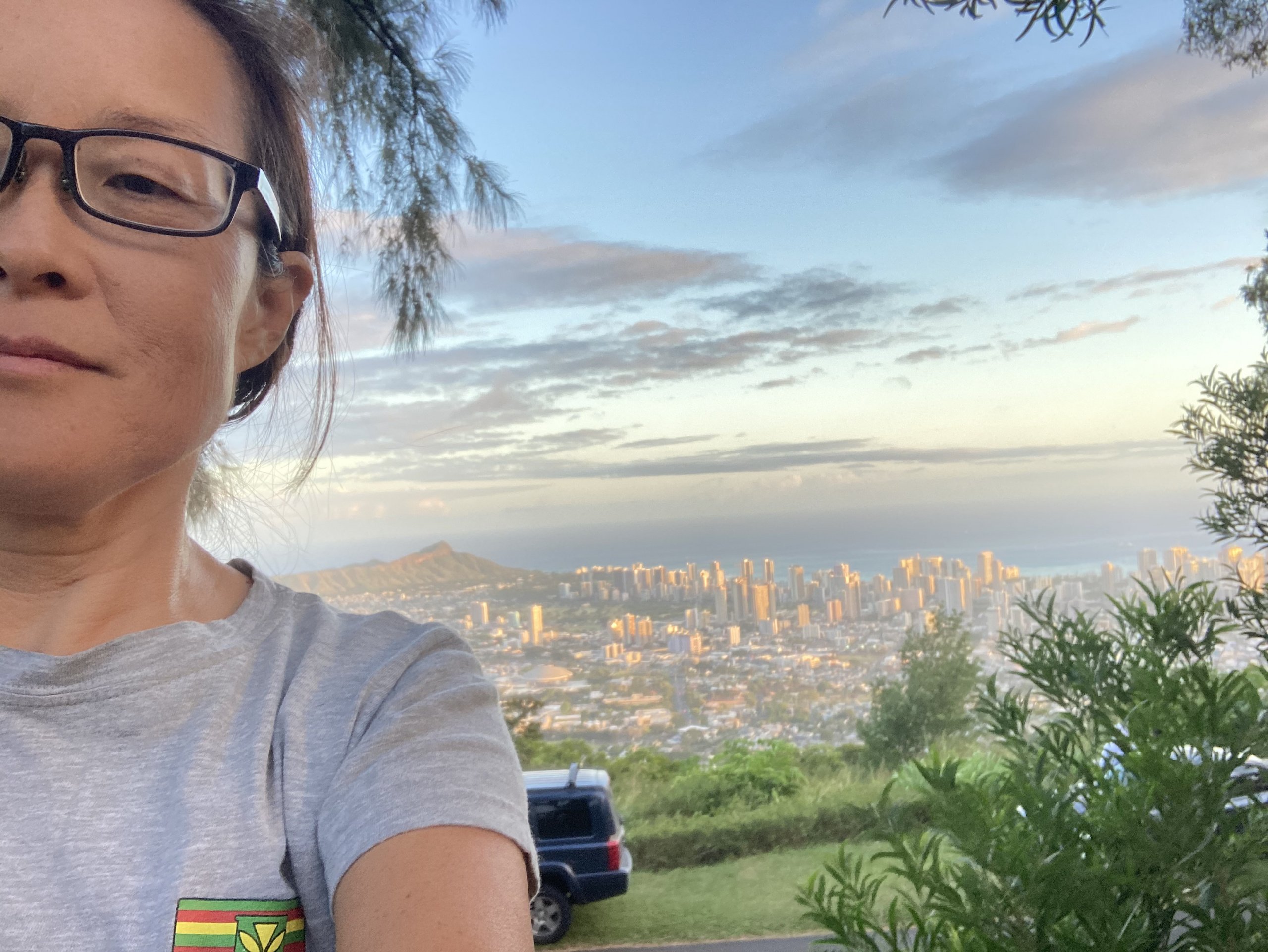 Dr. Stephanie Han wearing glasses in front of a scenic viewpoint